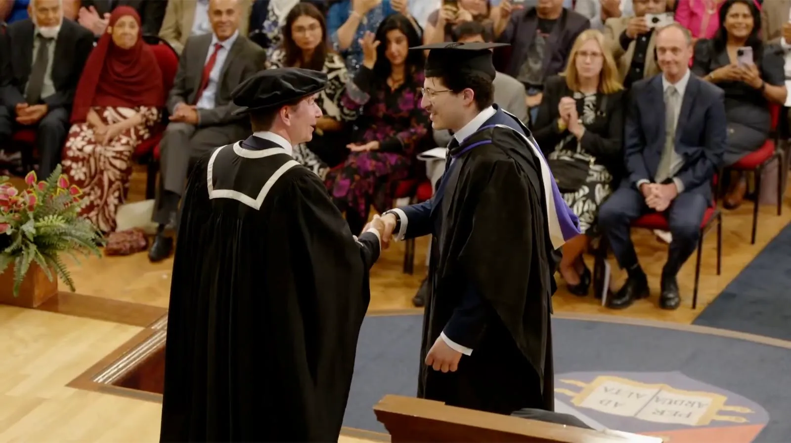 Shaking hands on stage at the graduation ceremony
